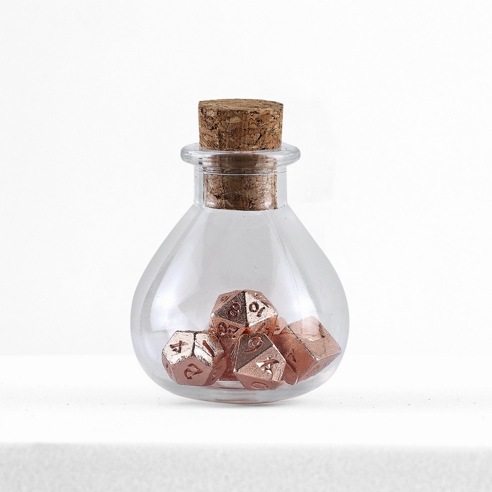 HYMGHO Unseelie Tiny Rose Gold RPG dice set in potion bottle